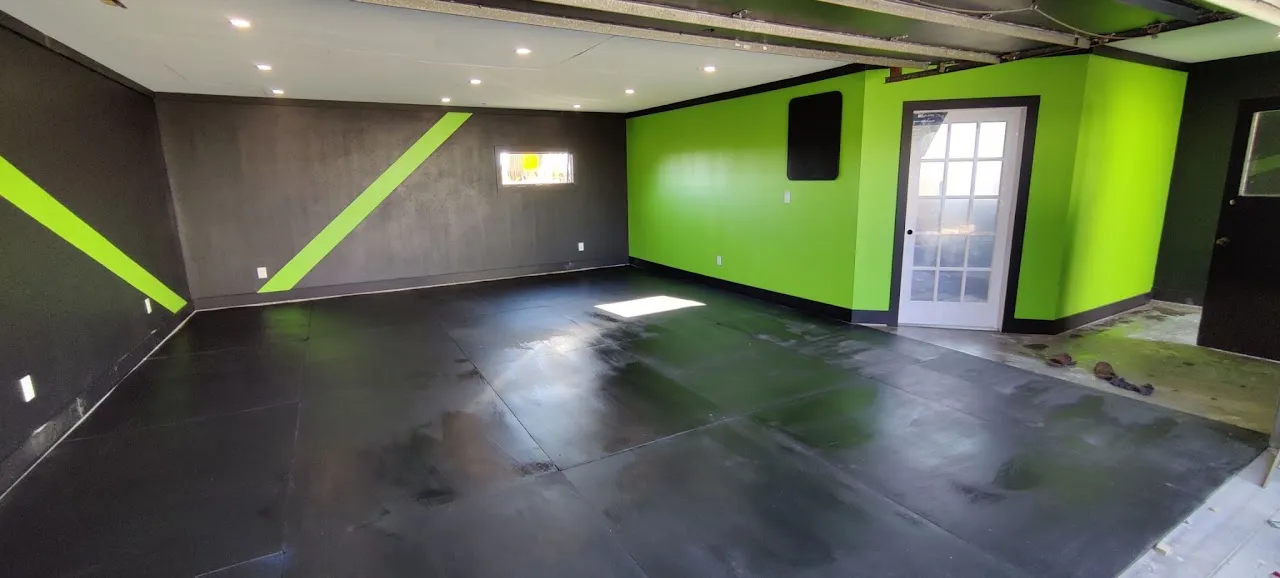 Finished shop interior with painted walls, sealed floor, and recessed lighting