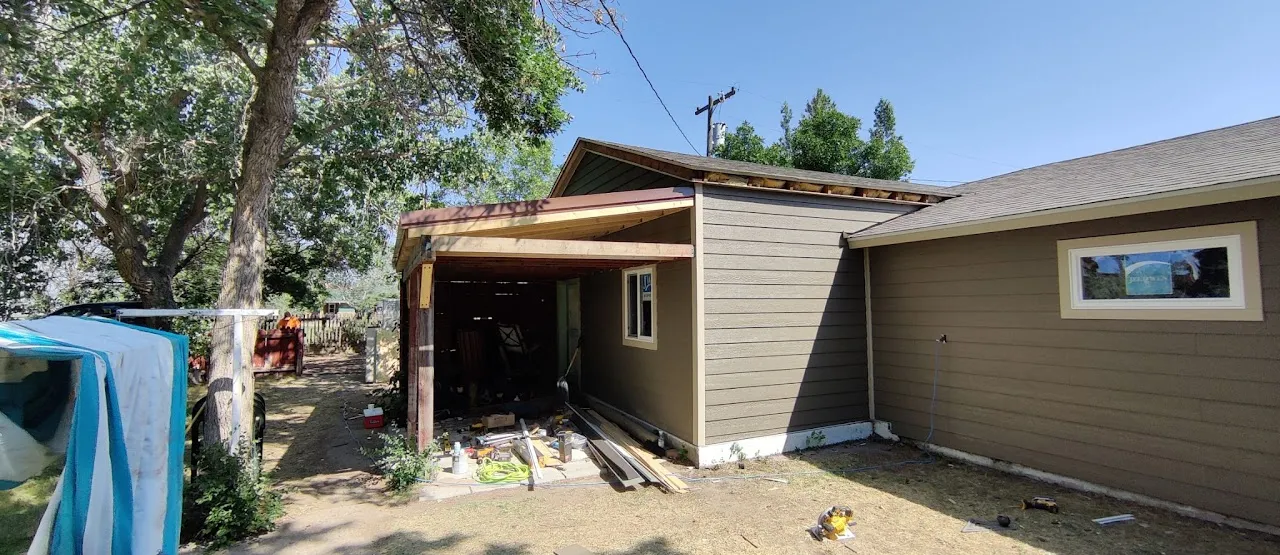 House with new lap siding and a covered entry under construction