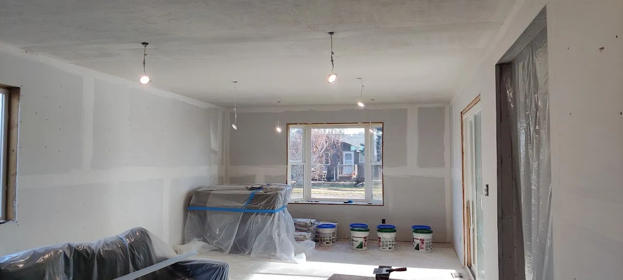 Room remodel in progress with new drywall hung and a new window installed